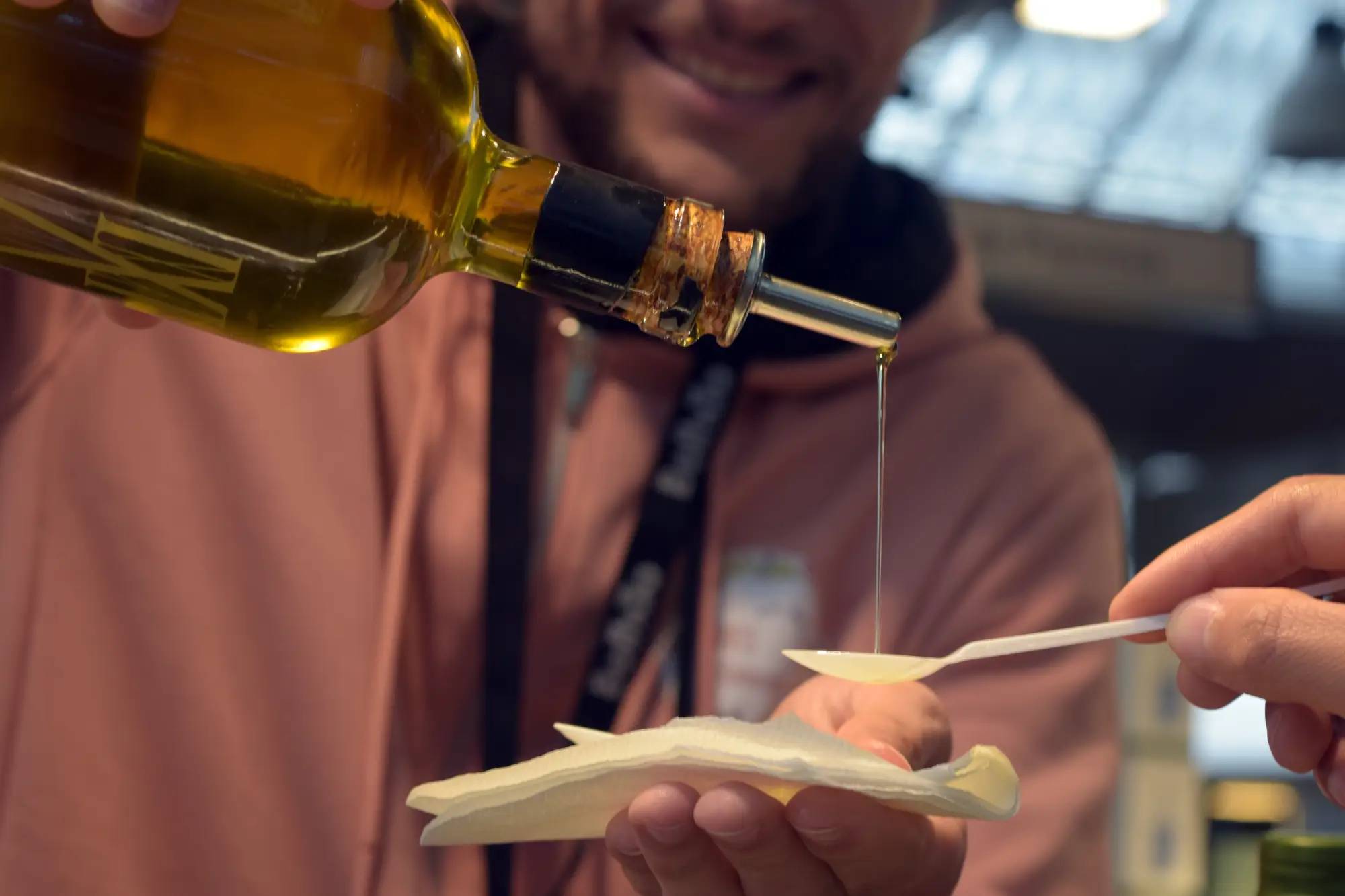 A man pouring olive oil